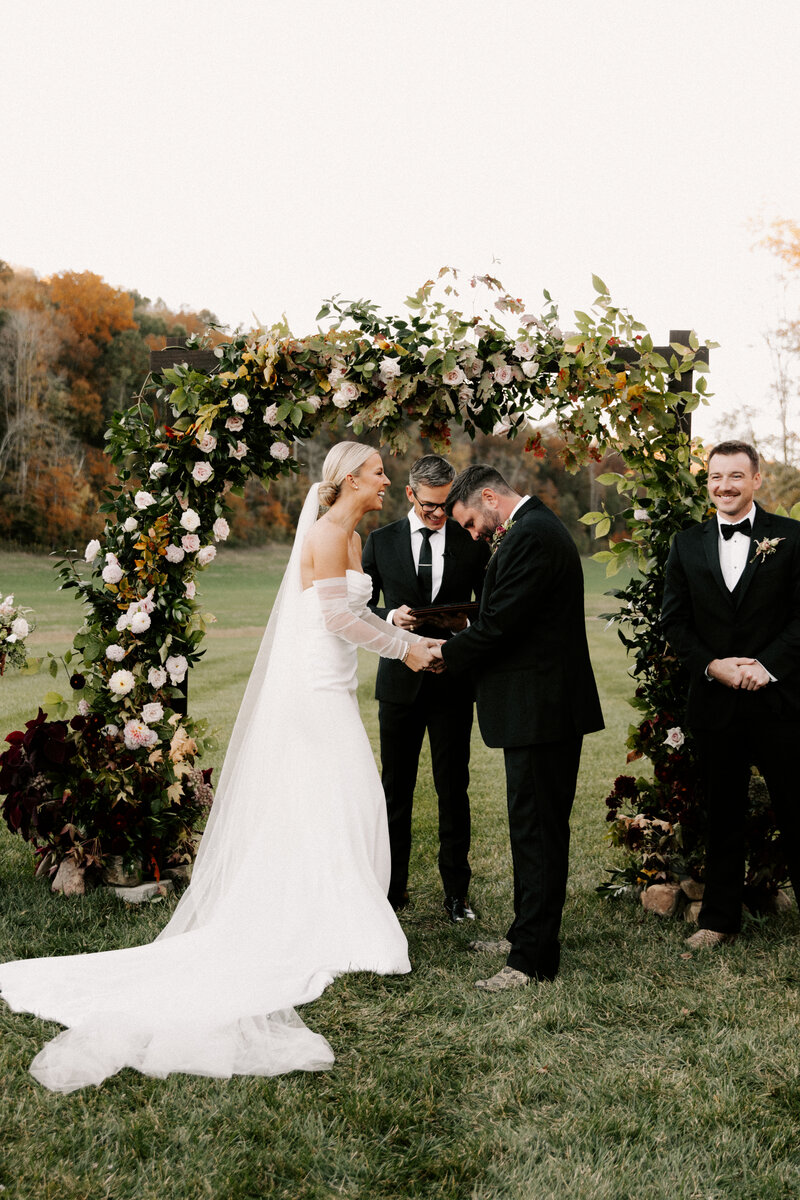 Nashville couple getting married under a floral arch