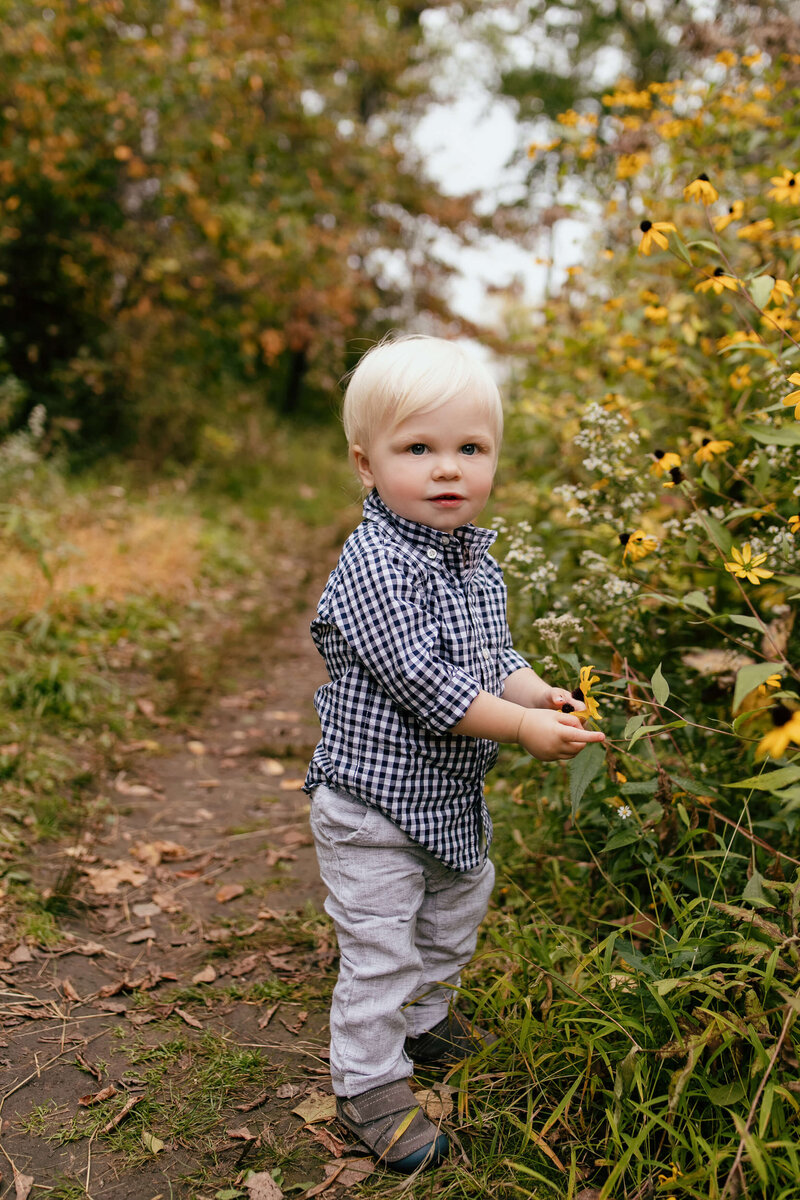 boy by yellow flowers