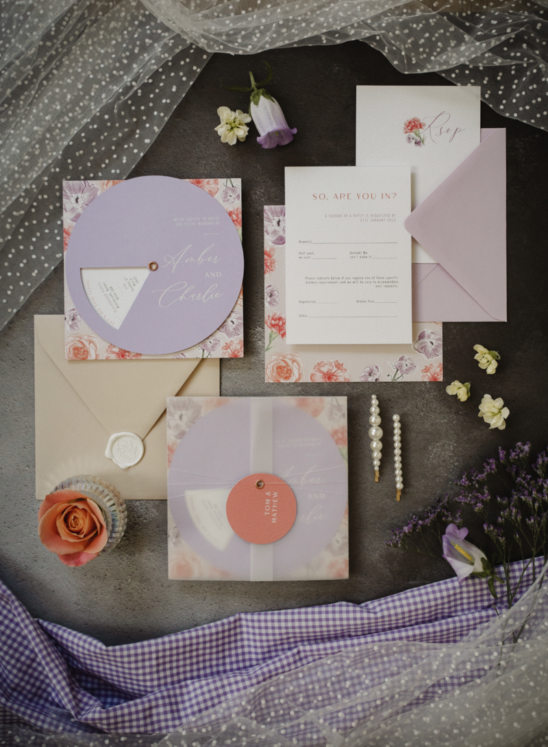 Flat lay of foiled and letter press wedding stationery suite