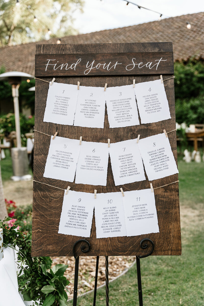 Seating chart cards displayed on a wooden board rental