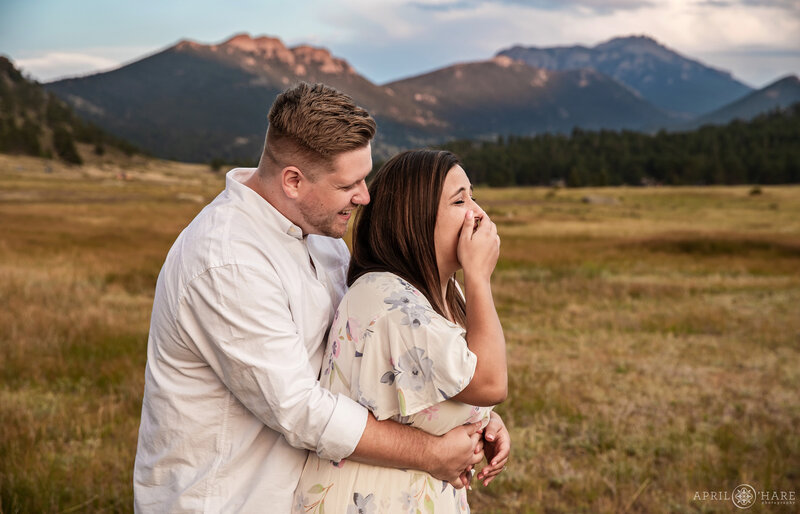 Couple laugh together at Moraine Park at Rocky Mountain National Park in Estes park