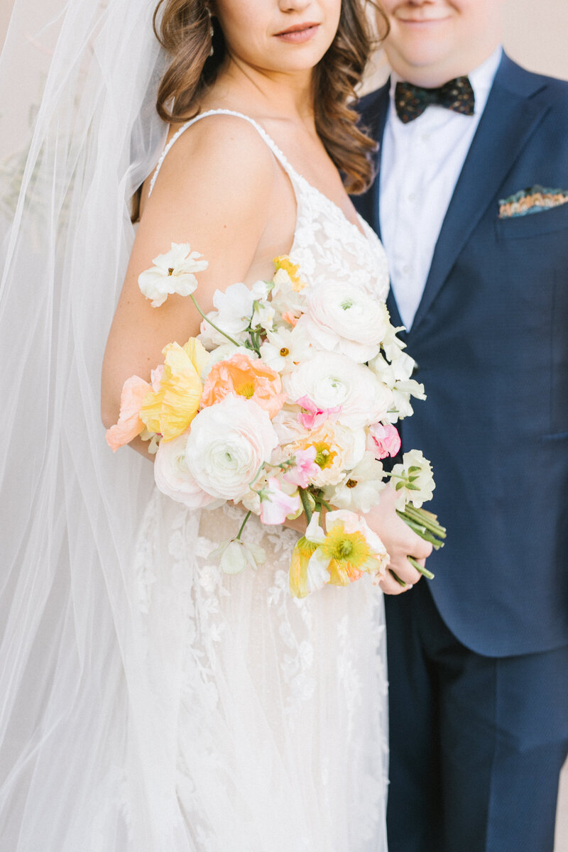 Bride and groom on wedding day with bouquet