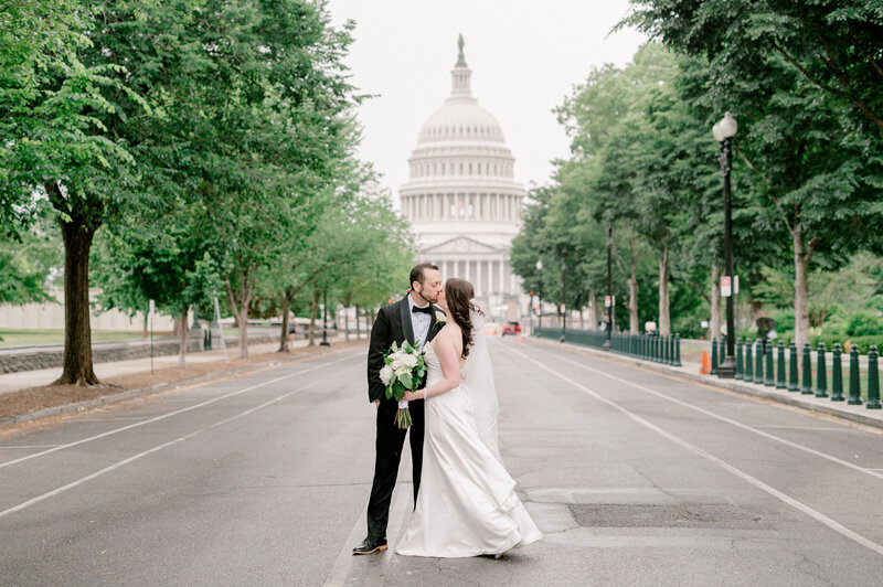 Timeless image of a bride and groom kissing in front of the DC Capitol building. Image captured by Virginia wedding photographer, Rachael Mattio