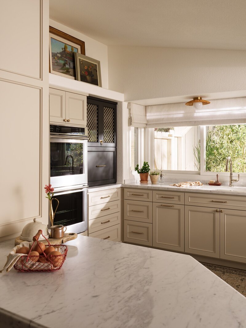 Orange county interior designer kitchen remodel. Custom black hutch with brass mesh cabinet doors and marble countertop in San Clemente kitchen.