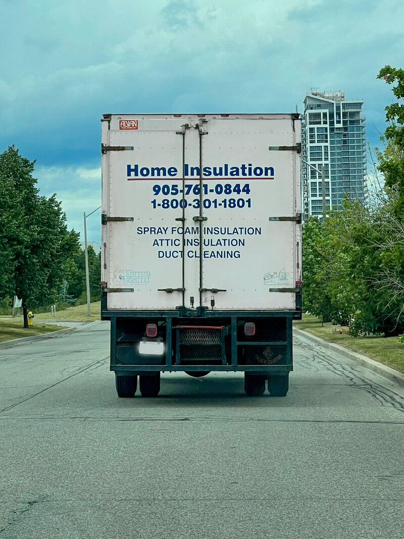 Back of home insulation truck along the road