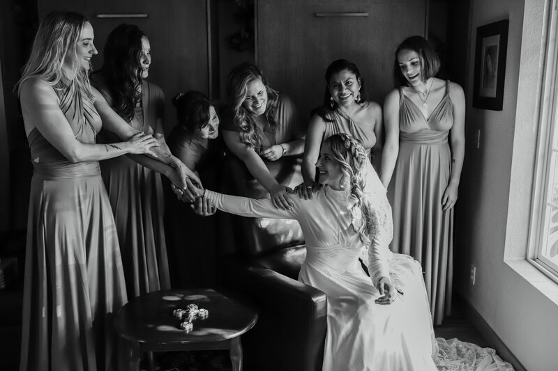 bridesmaids gathered around bride