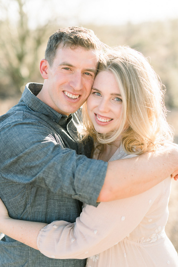 Tucson Desert Engagement Session Photo of Couple Smiling and Hugging | Tucson Wedding Photographer