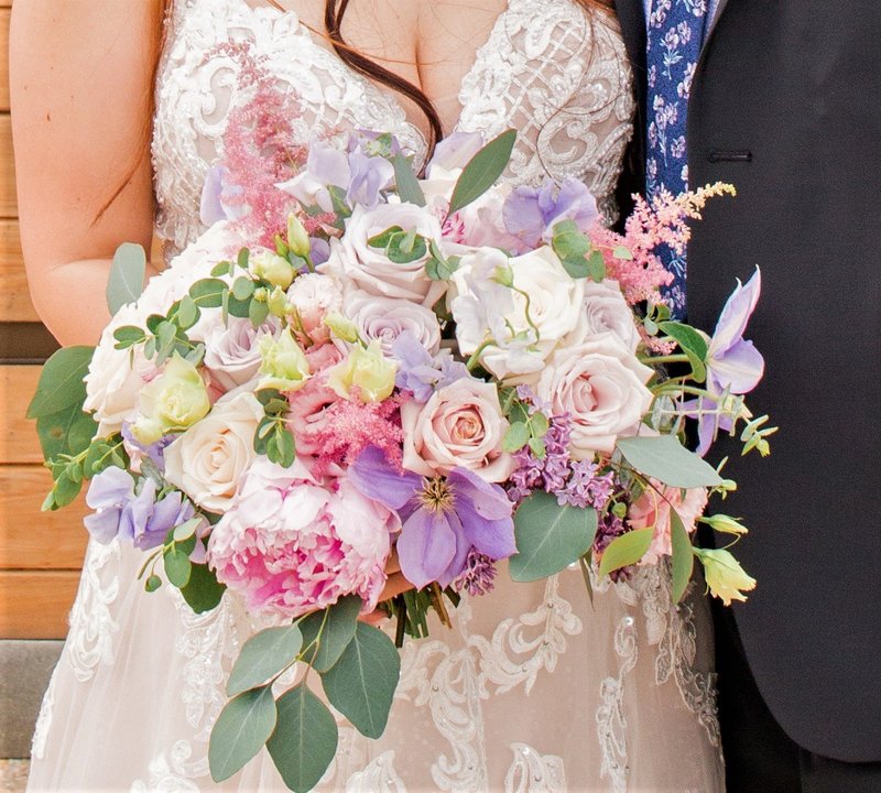 Pastel bridal bouquet with peonies, roses and clematis
