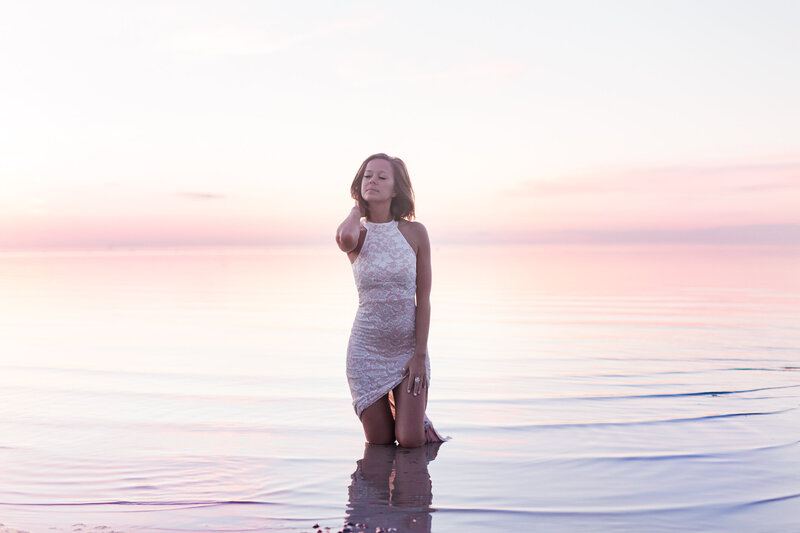 Sunset photo of beautiful girl in lace dress in Okanagan Lake