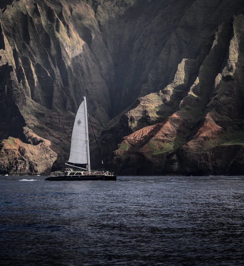 Sailboat drifts in the wind off the coast of Hawaii.
