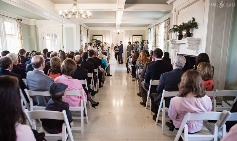 Wedding ceremony indoors on a winter day inside the Solarium at Highlands Ranch Mansion