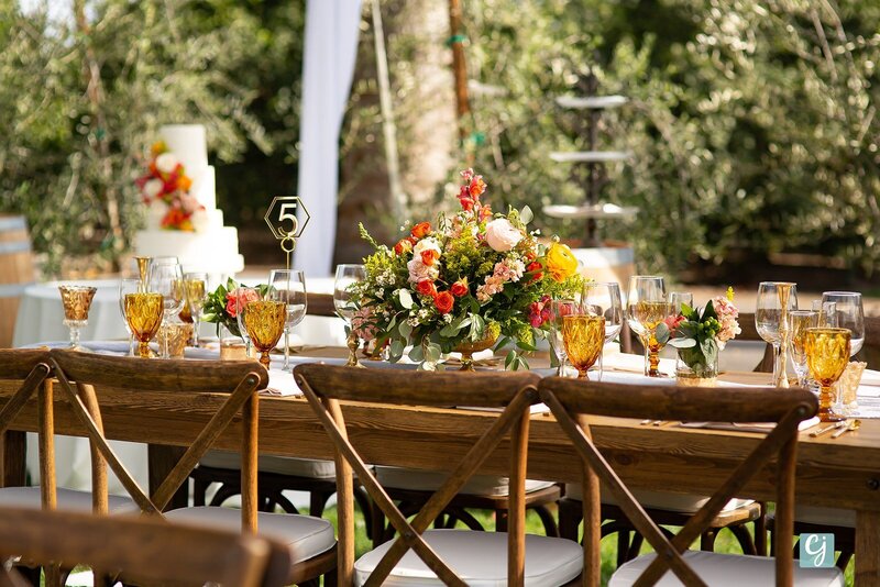 outdoor-tent-wedding-with-farm-tables-amber-glasses-with-crossback-chairs