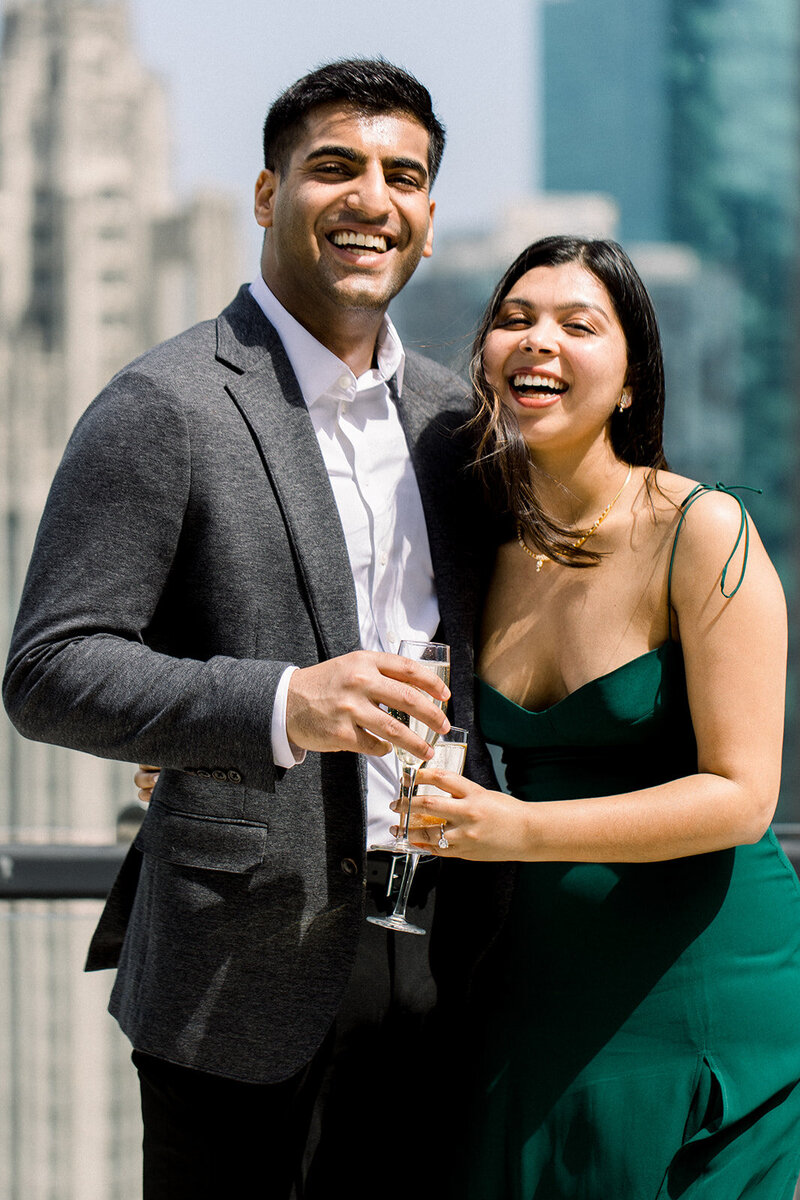 engaged couple toasting champagne