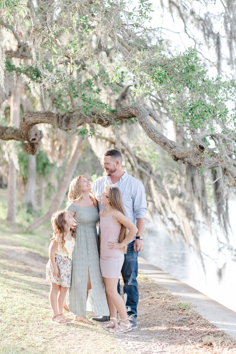 Family standing together near a hanging moss tree