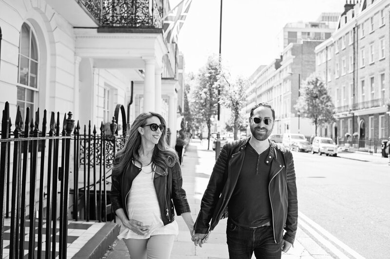 Couple holding hands as they walk down a road in London's Kensington & Chelsea