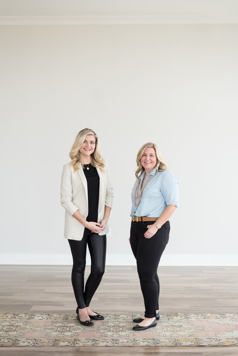 Nashville realtors standing in front of white wall for relaxed headshots