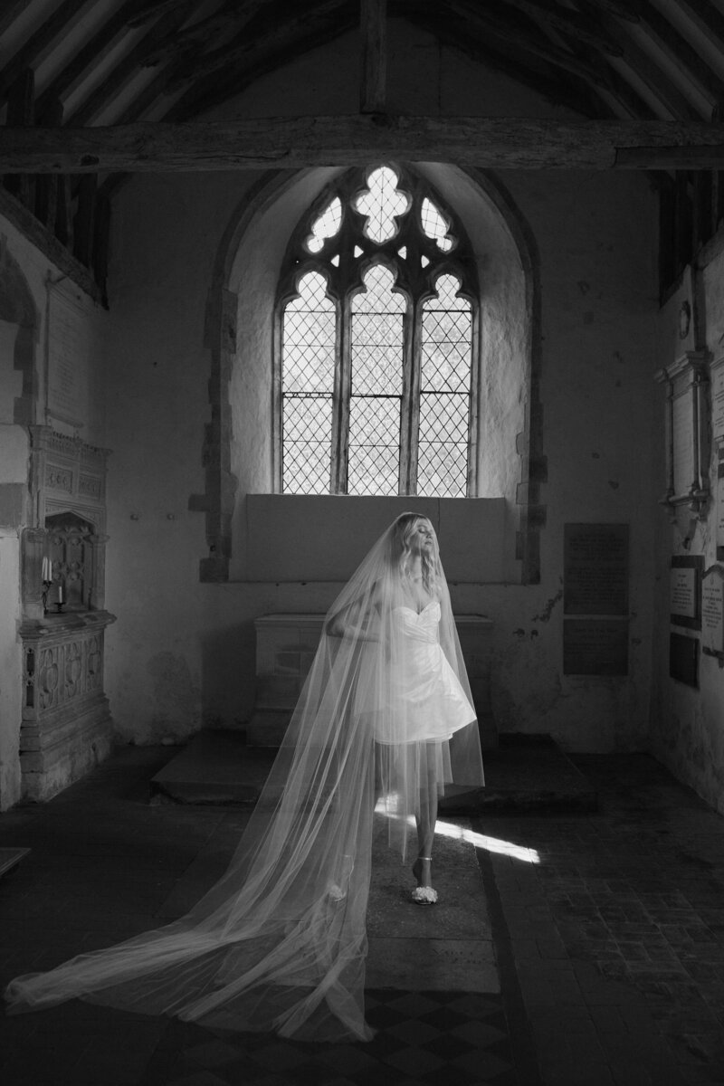 Bride wearing mini silk corset wedding dress in chapel