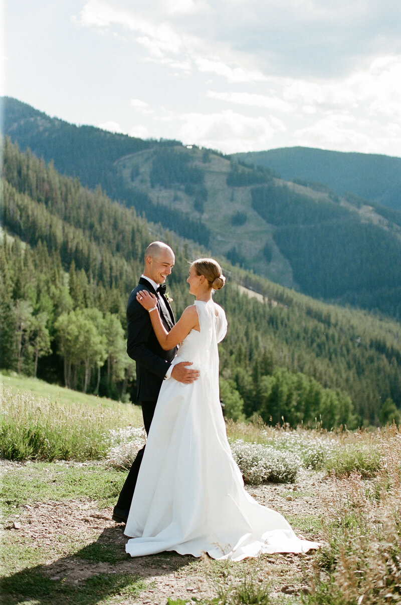 Bride and groom pose at the top of Beaver Creek Resort