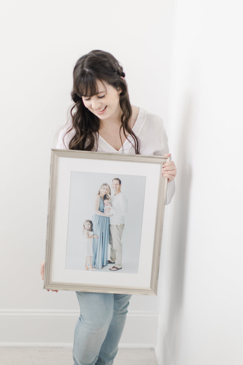 Photographer Stephanie Nunley with custom framed portrait.