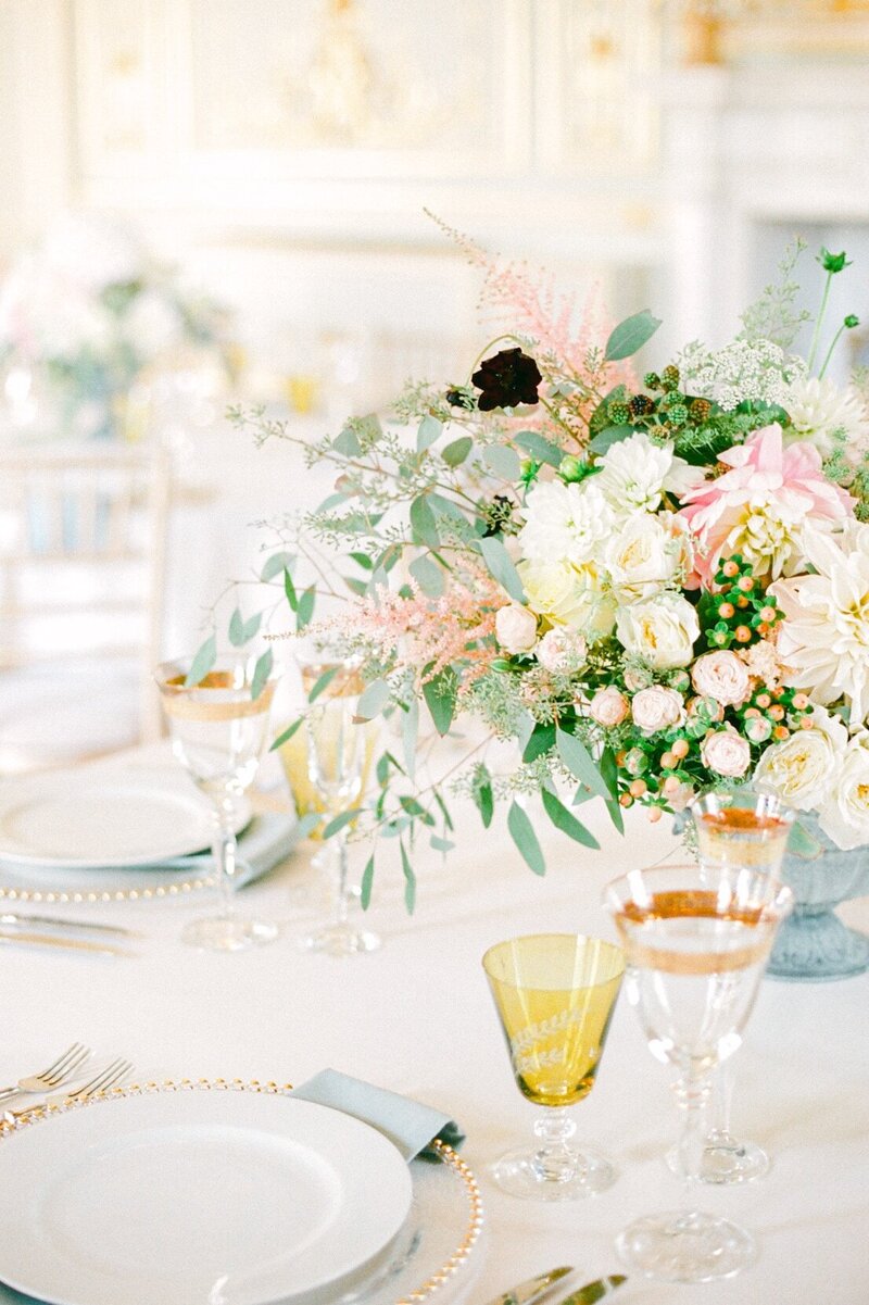 elegant pastel and gold table settings for a castle wedding