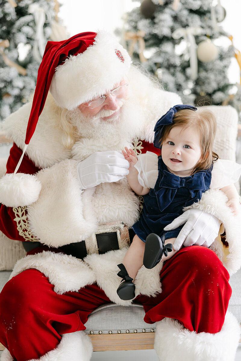 a boy smiling at Santa