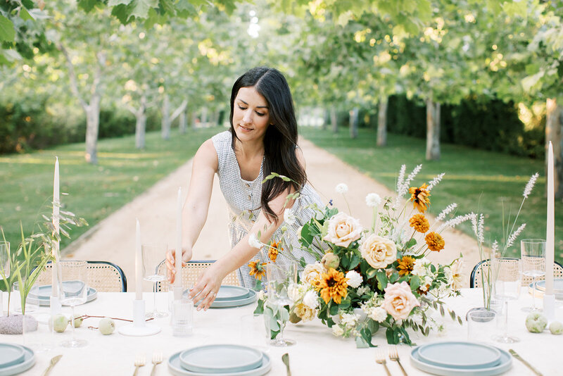 Florist styling a table with romantic florals in Artfully Arranged Online Course taught by Sarah Wahhab.