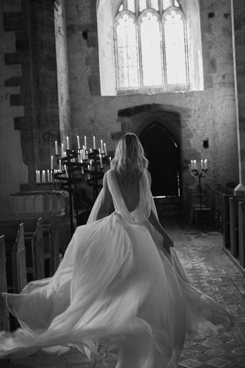 Low back silk wedding dress, long length on bride in church wedding