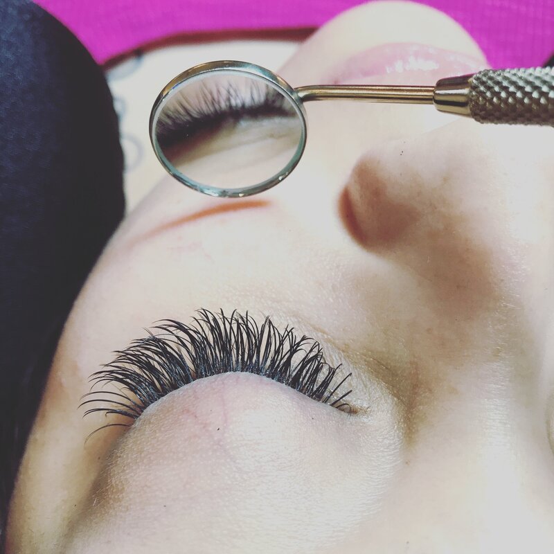lash extension being viewed in small mirror