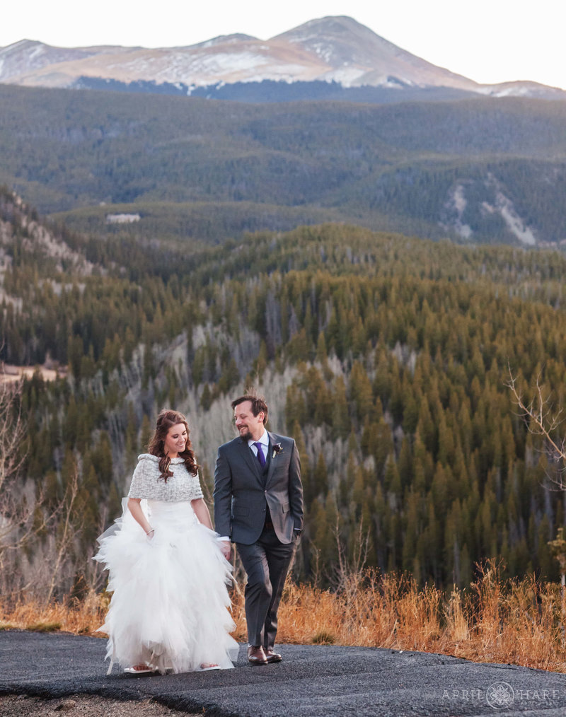 Couple walk along the path at Lodge at Breckenridge on their November wedding day in Colorado