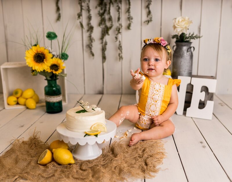 Baby smashing cake in photo studio