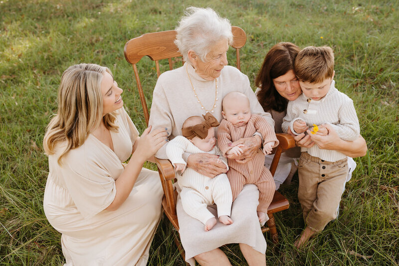 family sitting together in grass