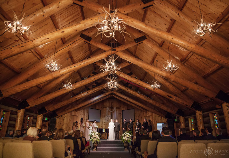 Indoor wedding ceremony at rustic Agape Outpost Chapel in Breckenridge Colorado