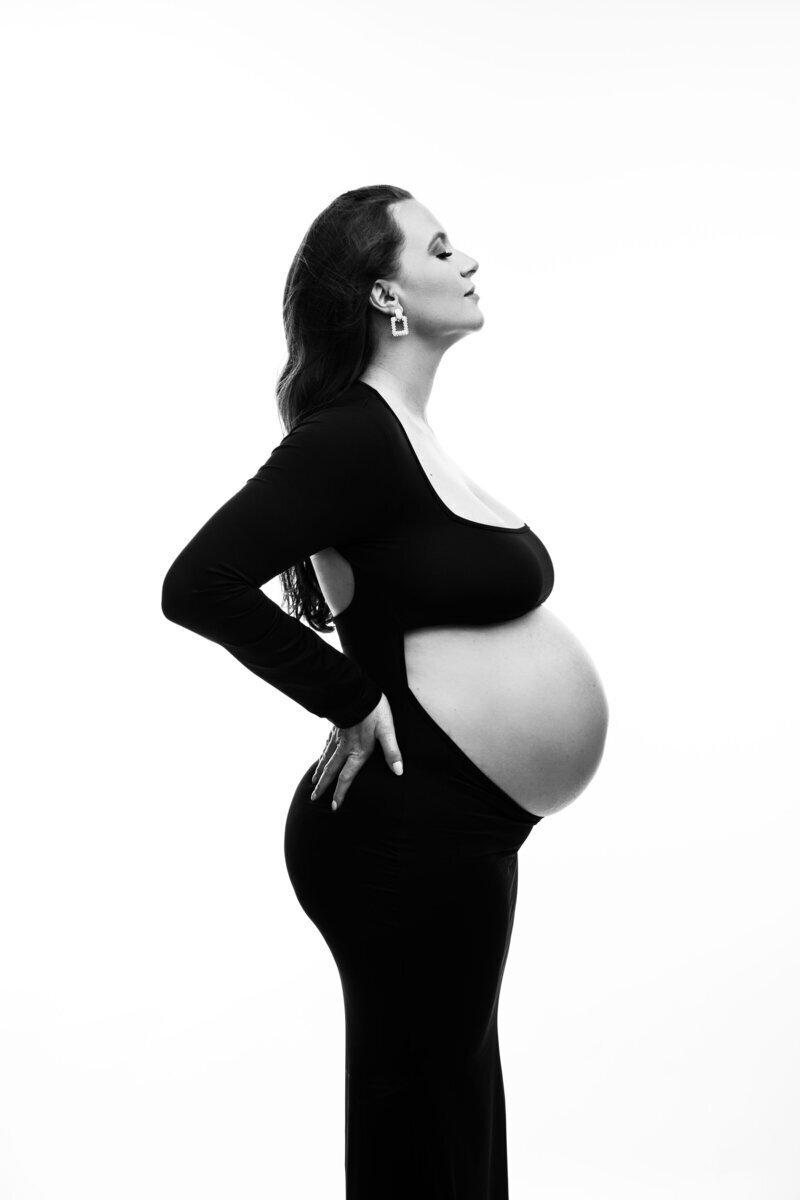 Side profile of pregnant mom showing off baby bump, by best maternity photographer nj
