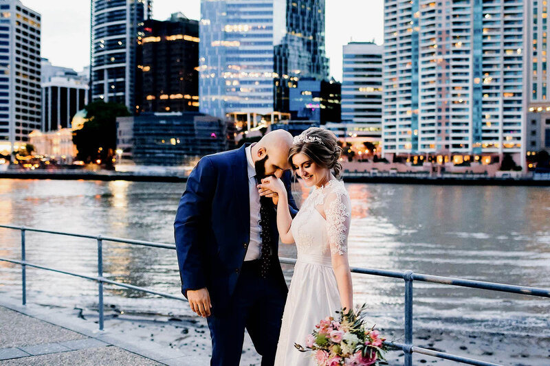 Groom kissing Bride's hand at Brisbane City