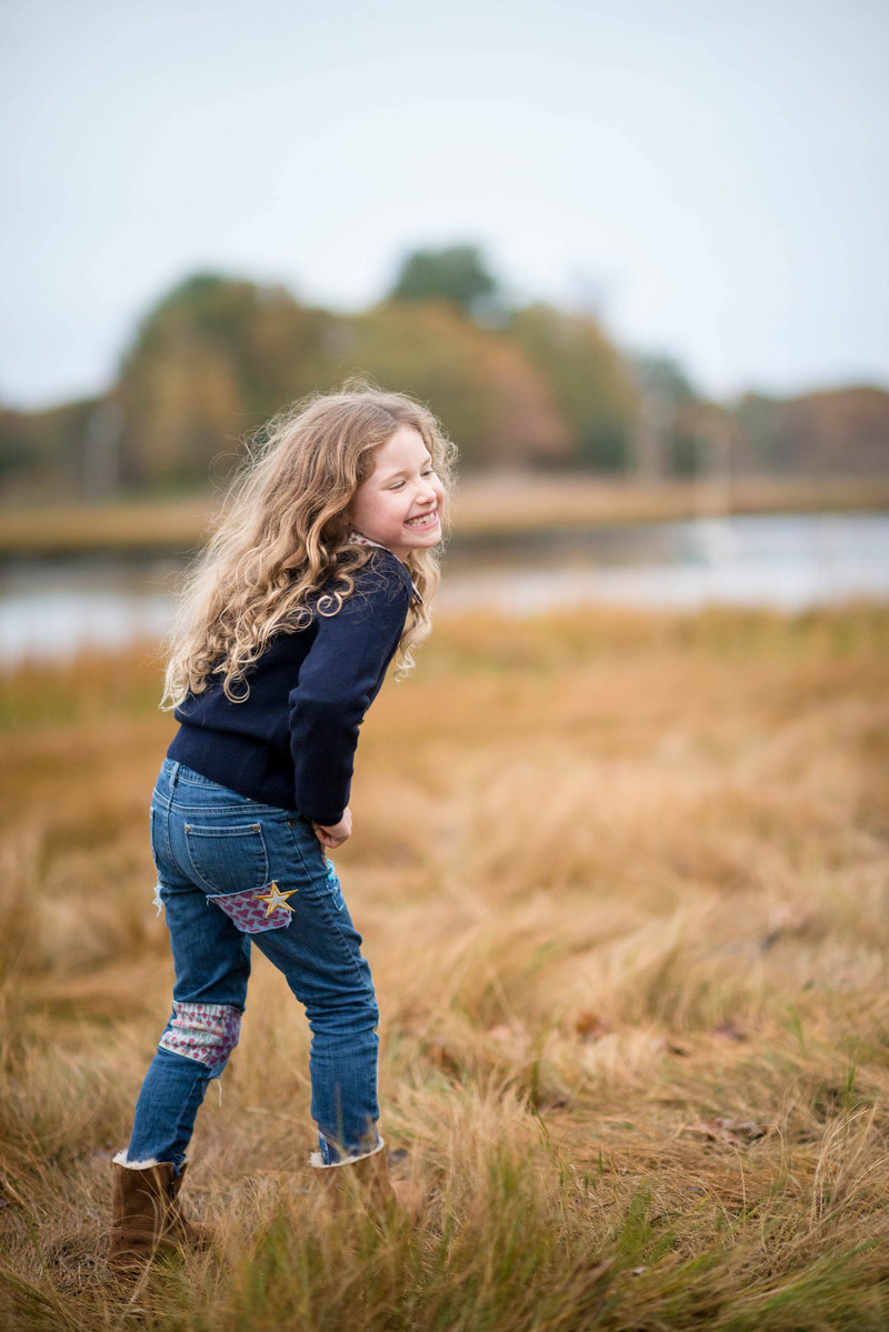 girl smiling at her brother during family photography session