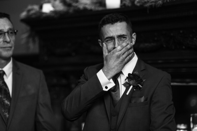 Groom covers his mouth and begins to cry when he first sees bride walking down the aisle at Peek n Peak wedding