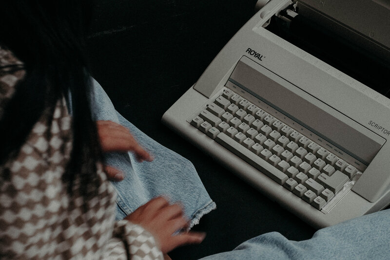 hands typing on vintage royal typewriter