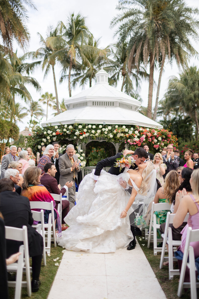 Bride and groom walk towards building