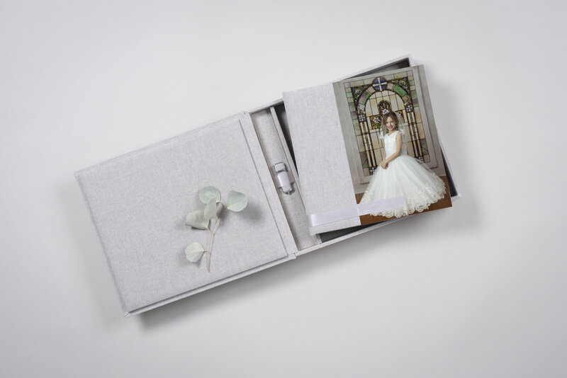 Details of a communion photo album in a commemorative box sitting on a table