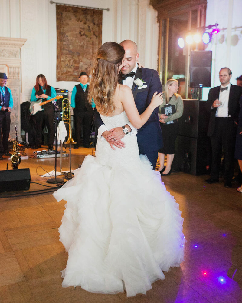 Candid of Groom holding Bride as they dance on dance floor