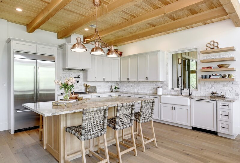 White kitchen with wooden ceiling with beams