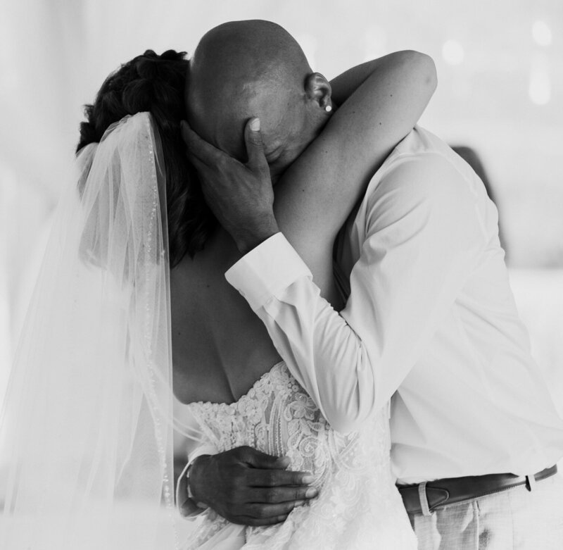 Groom cries as he holds his bride during their first dance