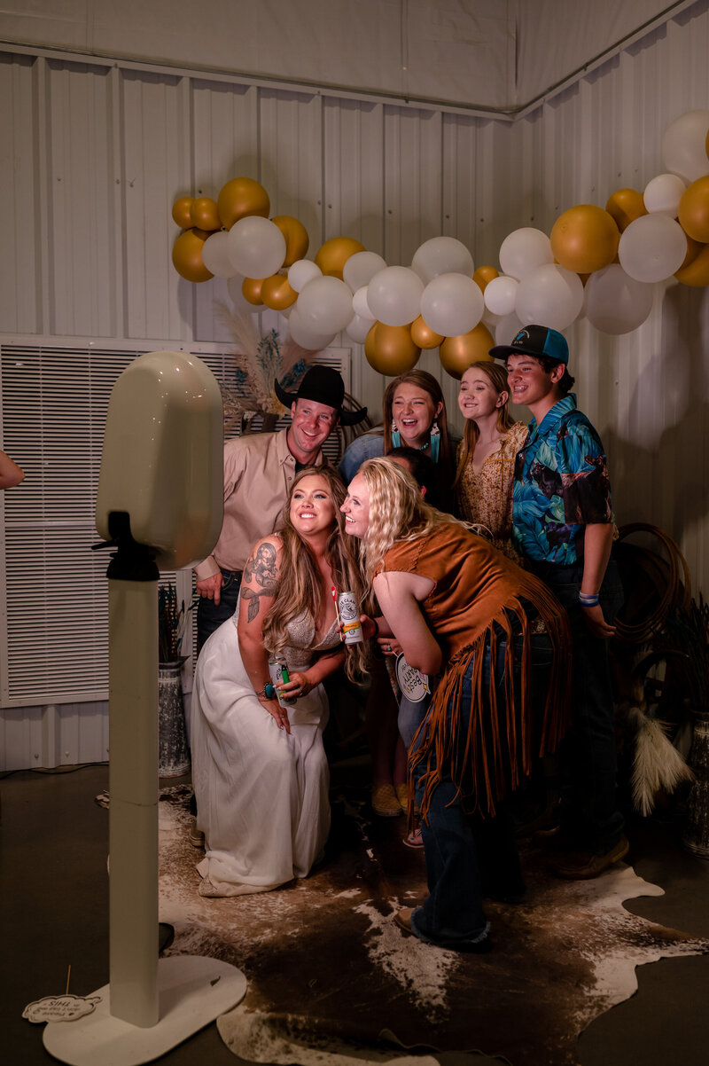 A group of people huddling for photo booth photo