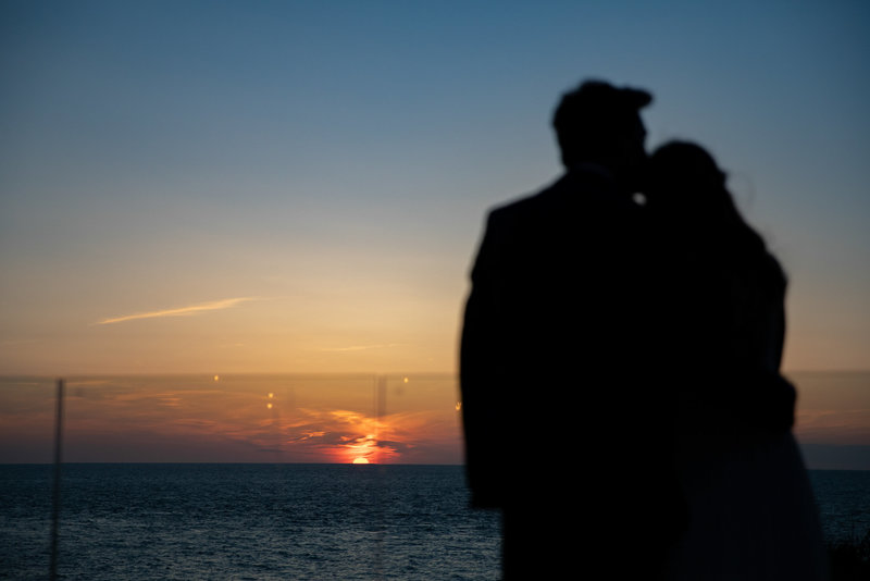 Watching the sunset on your wedding day at Tunnels Beaches Devon