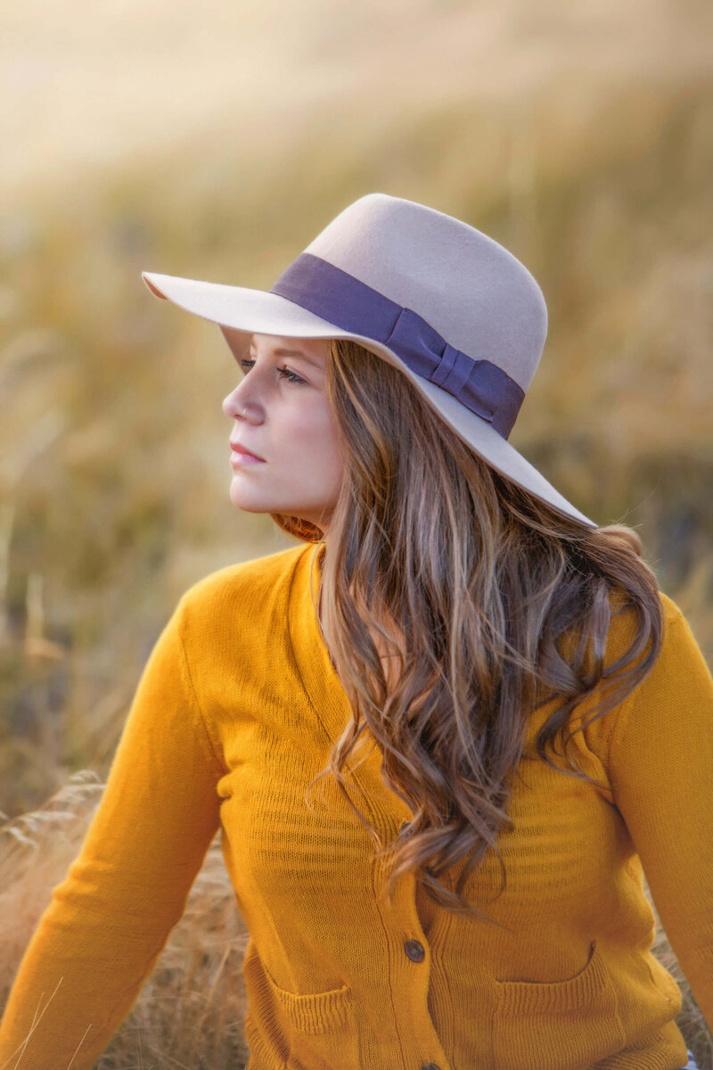 beautiful girl in hat looking into distance
