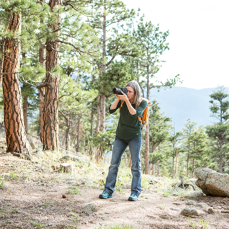 Nichole taking photographs in the forest