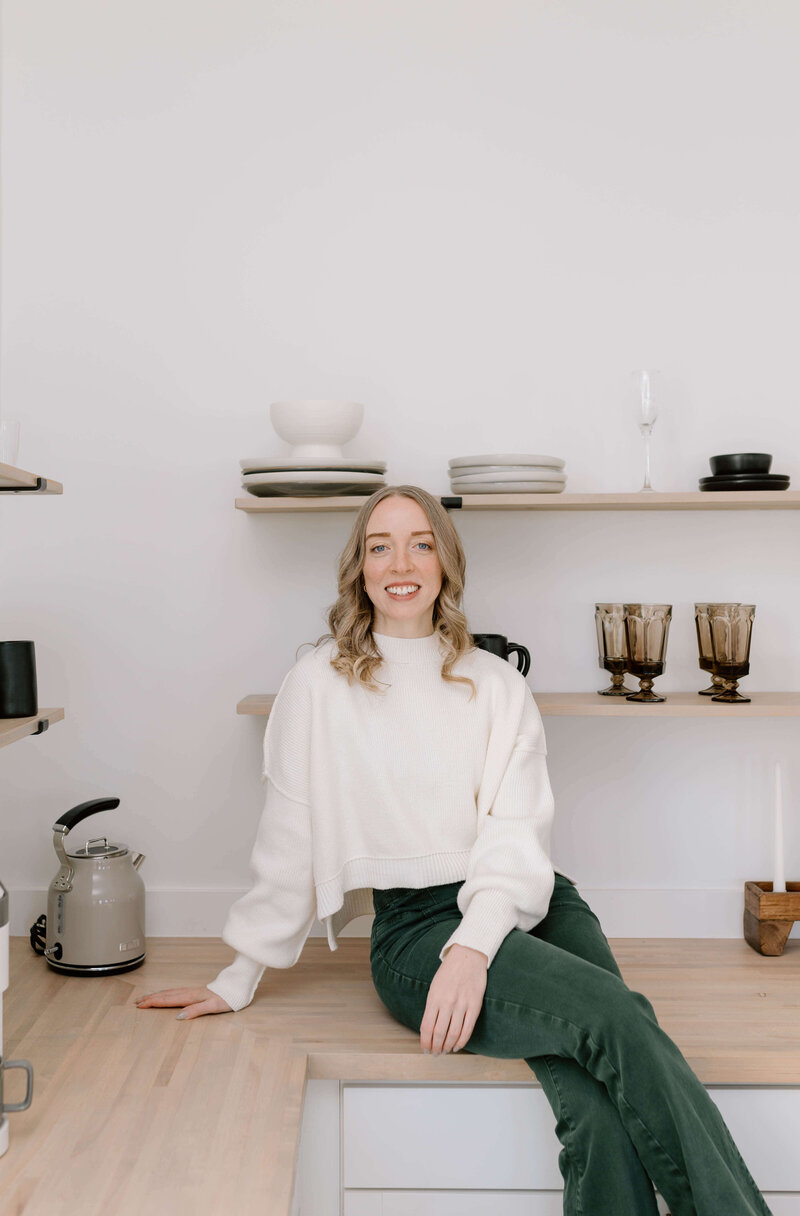 woman smiling sitting on counter