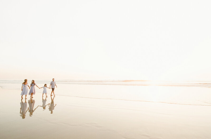 Family Photographer, family of 4 walking along the beach