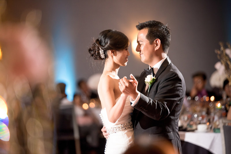 A candid picture of a bride and groom sharing their first dance
