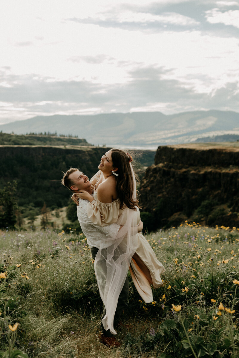 Elopement couple dances in the Columbia River Gorge at Rowena Crest in a field of wildflowers